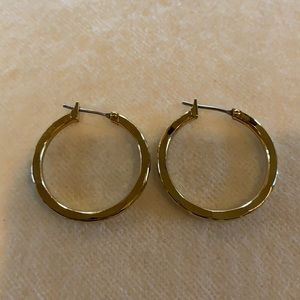 Gold hoop earrings with x cut detailing